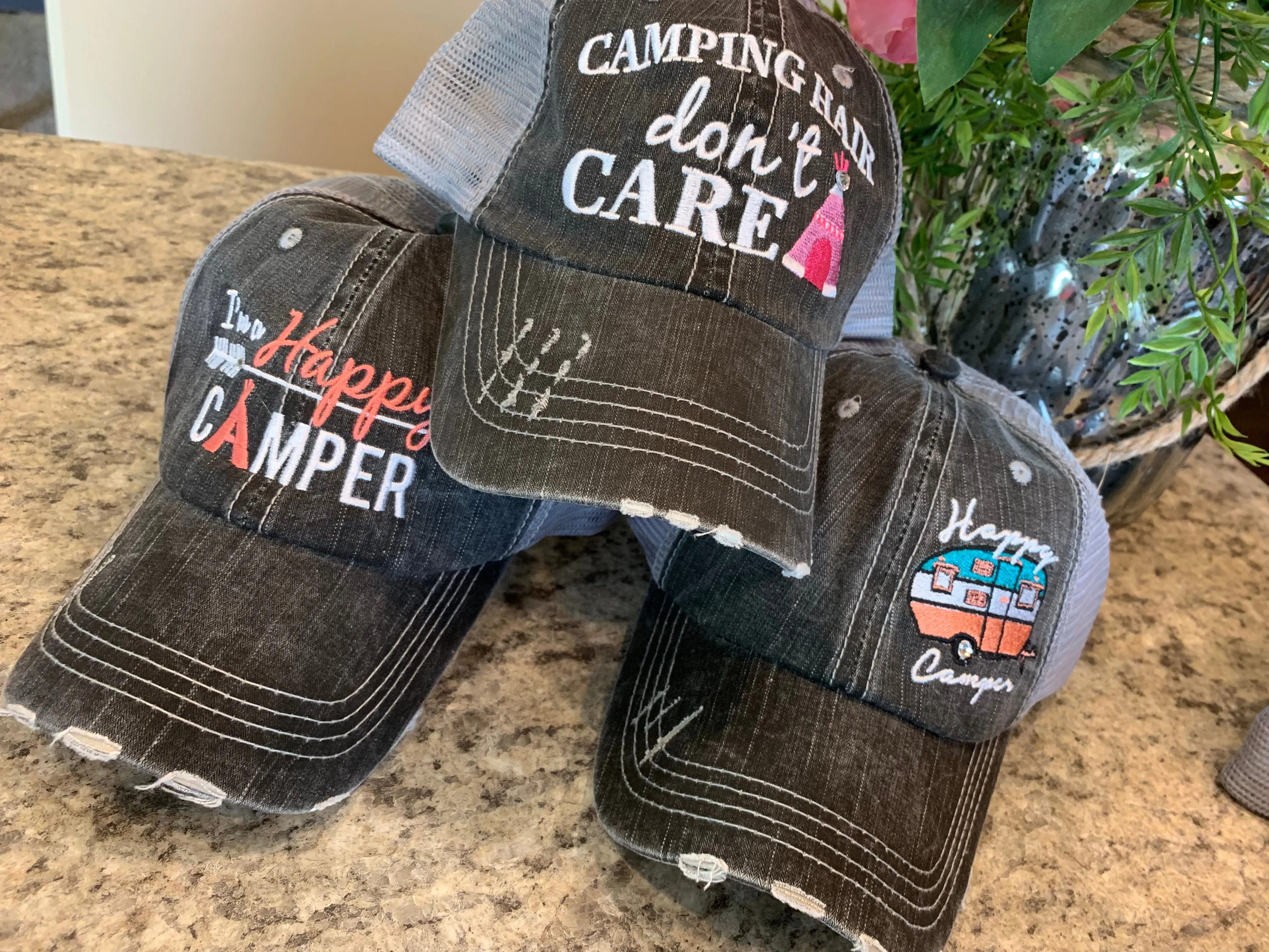 Hats or tanks { I'M A HAPPY CAMPER } { Camping hair don’t care } { Camping life } { Glamping hair don’t care } Embroidered distressed gray unisex trucker caps. Adjustable Velcro and hole for pony. RV there yet?